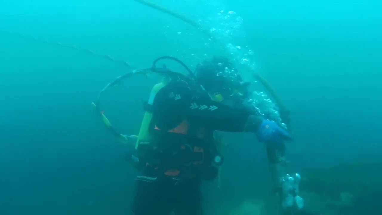 Underwater drilling using a pneumatic drill.