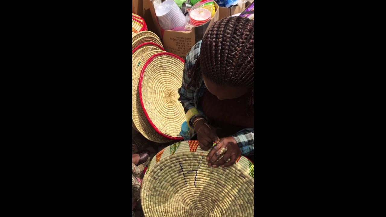 Ethiopian woman weaving a traditional basket in Addis Ababa - June 2015
