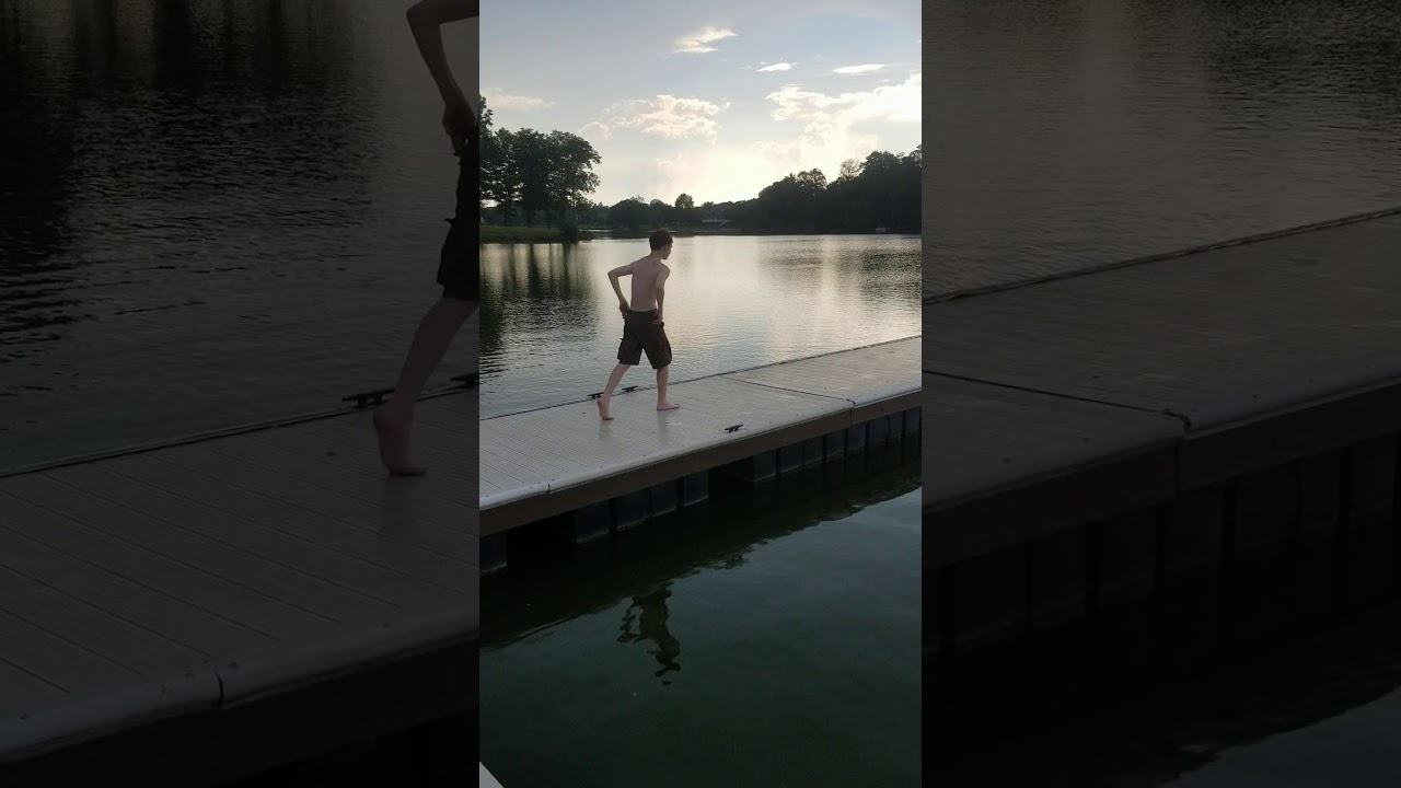 Kid swims in lake with only his underwear on