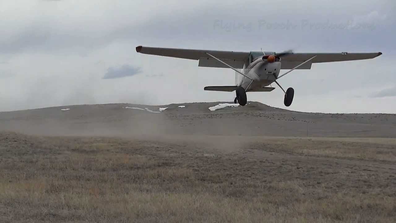 Cessna 180 landing short in windy conditions.