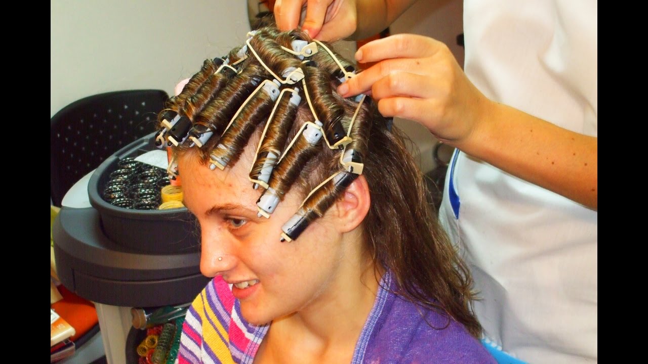 Teenager getting a rollers perm and a short haircut