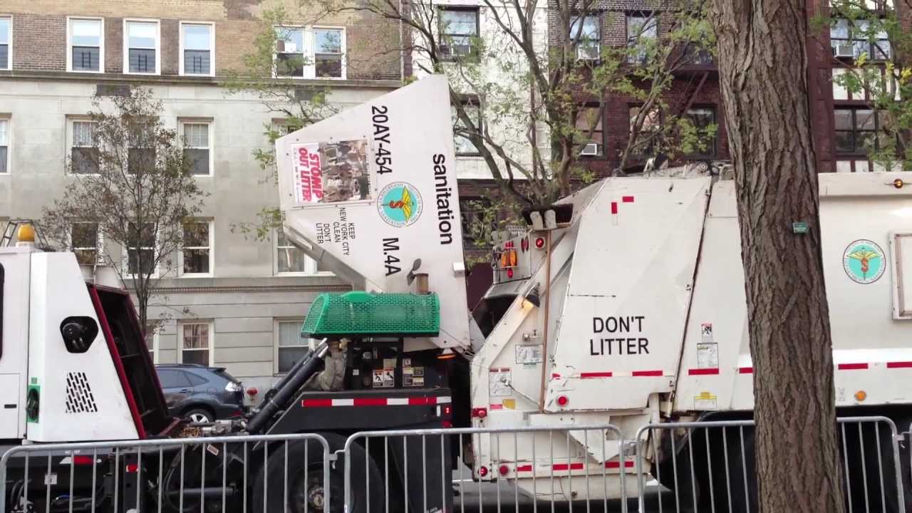 RARELY SEEN PROCEDURE OF A DSNY STREET SWEEPER EMPTYING CONTENT INTO A DSNY GARBAGE COLLECTION TRUCK