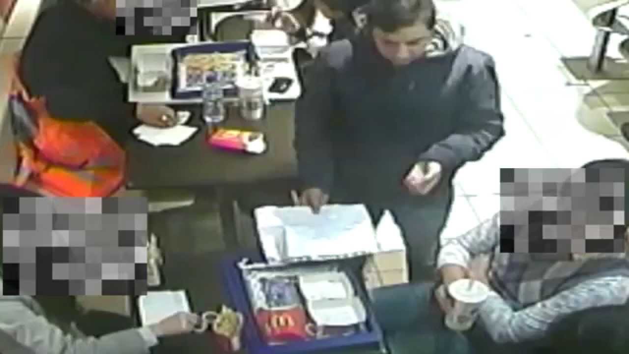 CCTV footage of thief distracting a diner whilst stealing their mobile phone