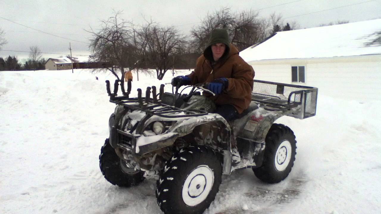 Four wheeler going though snowdrifts