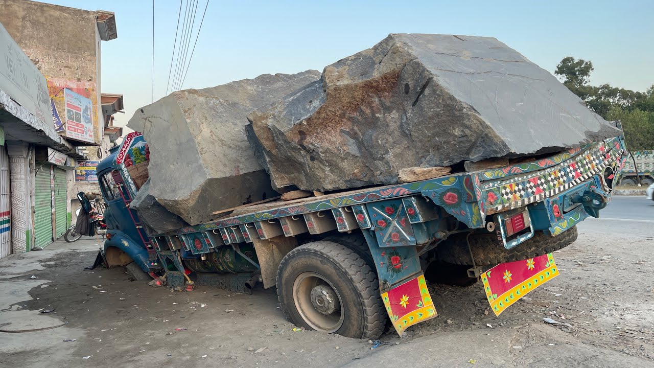 Heavy Load Disaster — Truck Breaks Under Big Stone.