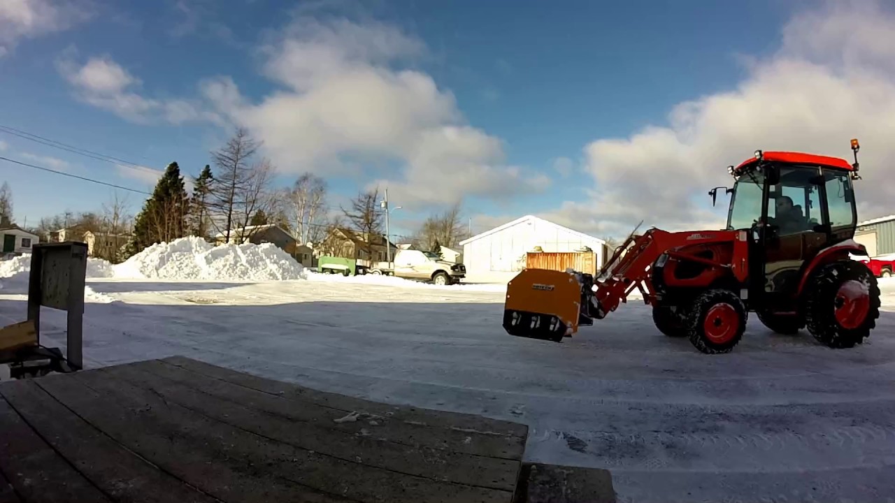 Kioti tractor snow clearing the parking area