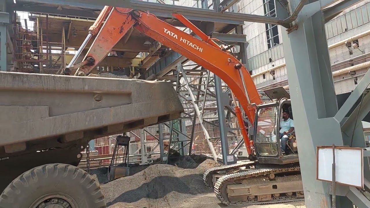 Excavator loading haulpack dumper...