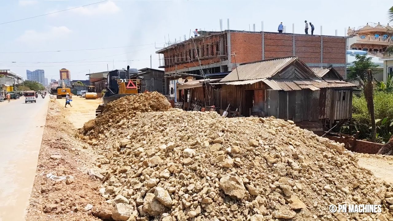 New Action Of Building Foundation Road In Village By Dump Truck & Bulldozer Komatsu Pushing Stone