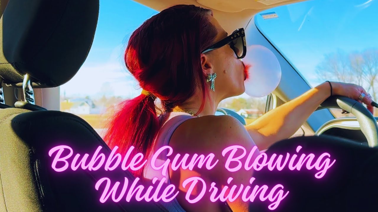 Backseat View of Bubble Gum Blowing while Driving