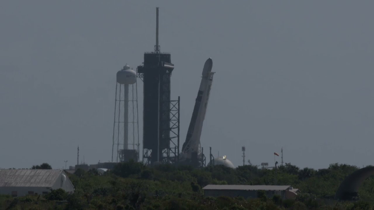 A SpaceX Falcon 9 stands upright at Launch Complex 39A