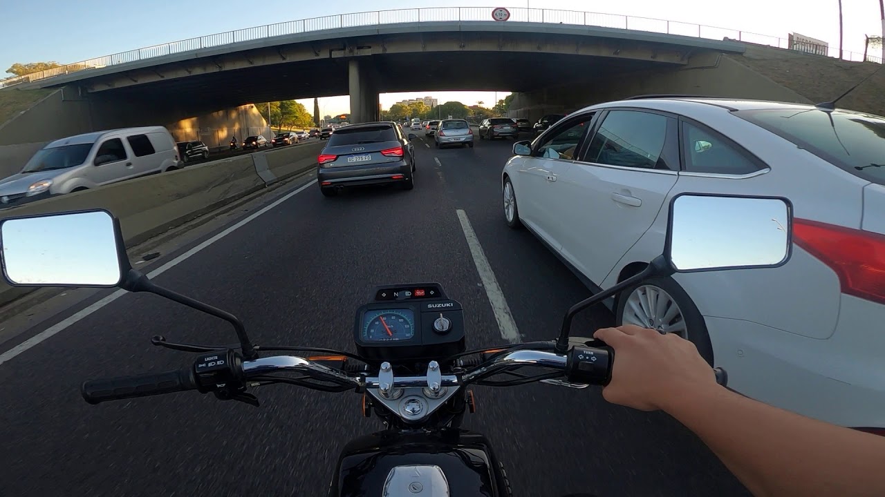 Suzuki ax 100 onboard con escape macondo y carburador cortina plana 28 mm