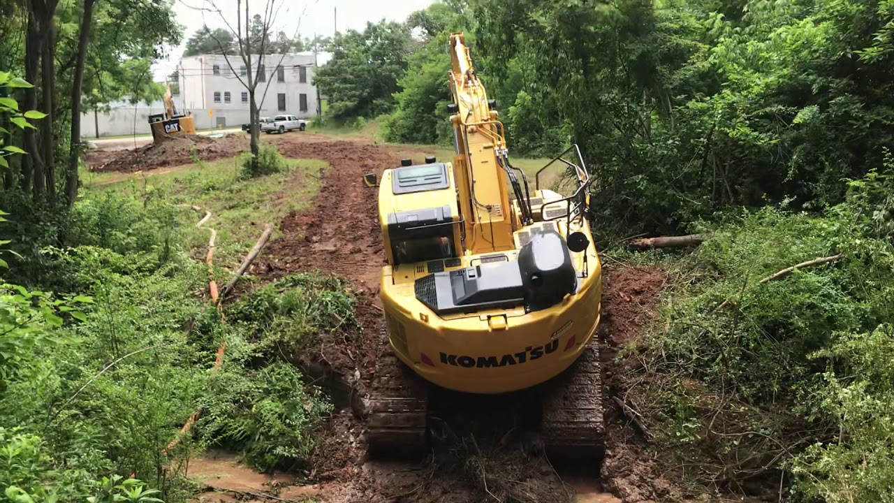 Komatsu Pc238-11 Climbs Out Of Deep Creek