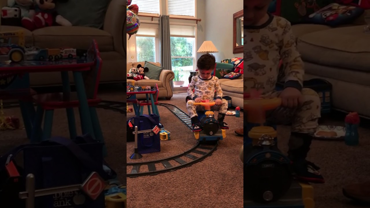 Little Boy Riding on his Automated Toy Train