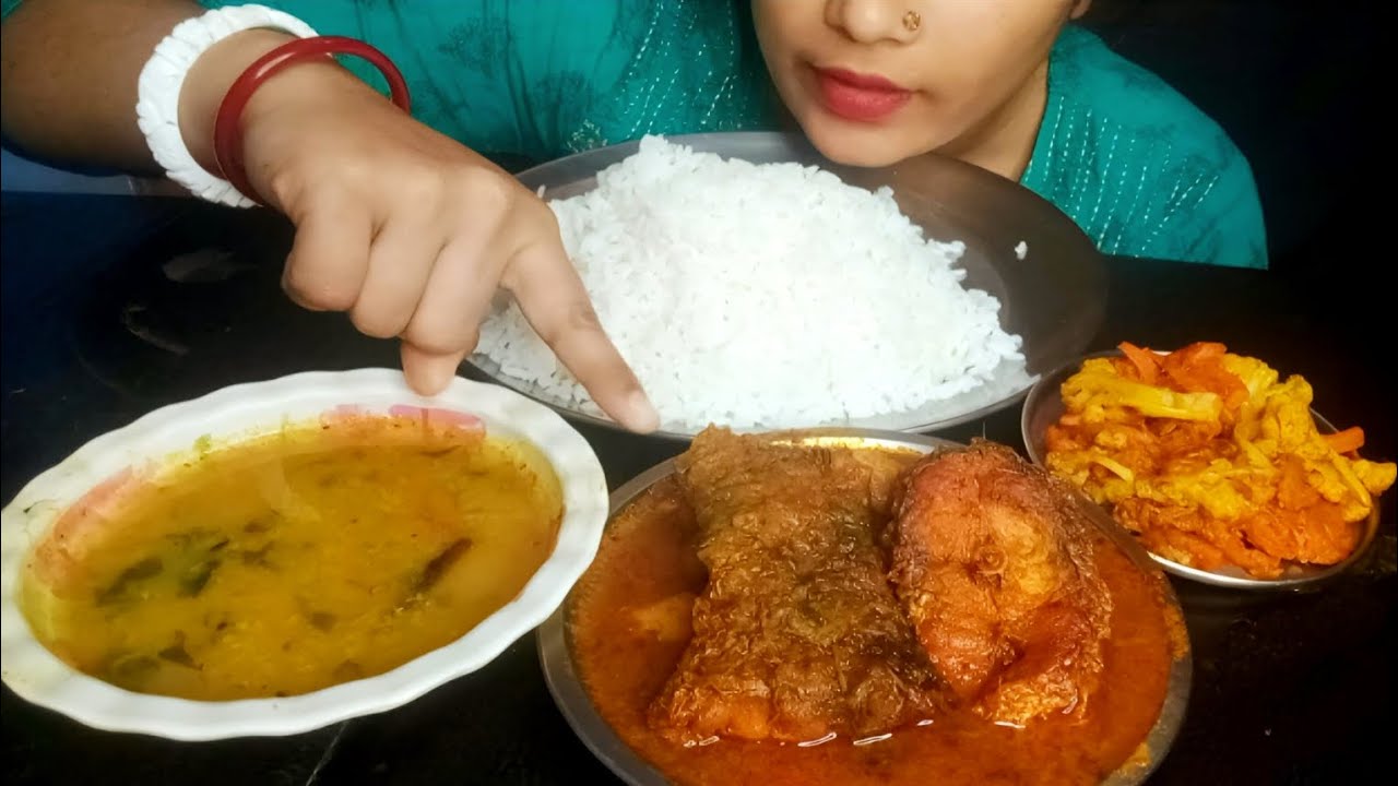 Eating show rice, macher jal, sobji vaja with dal.
