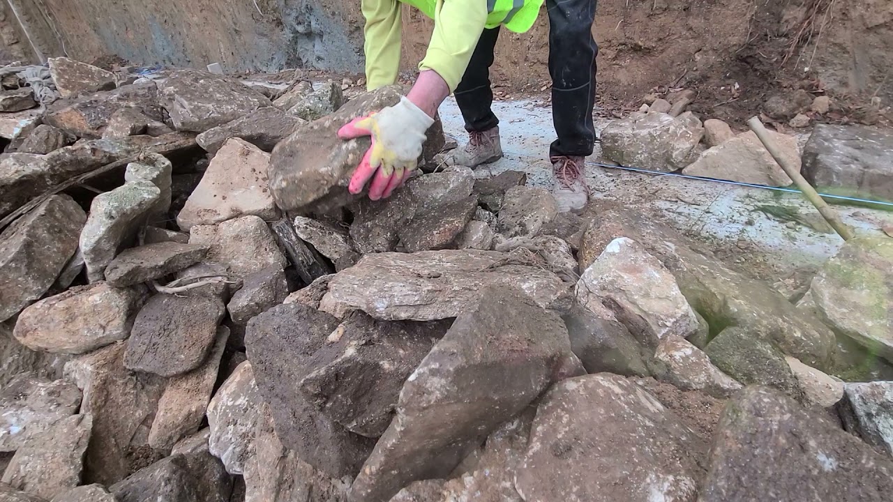 This image will show you how to pile up the stone wall with natural stones in a rural house
