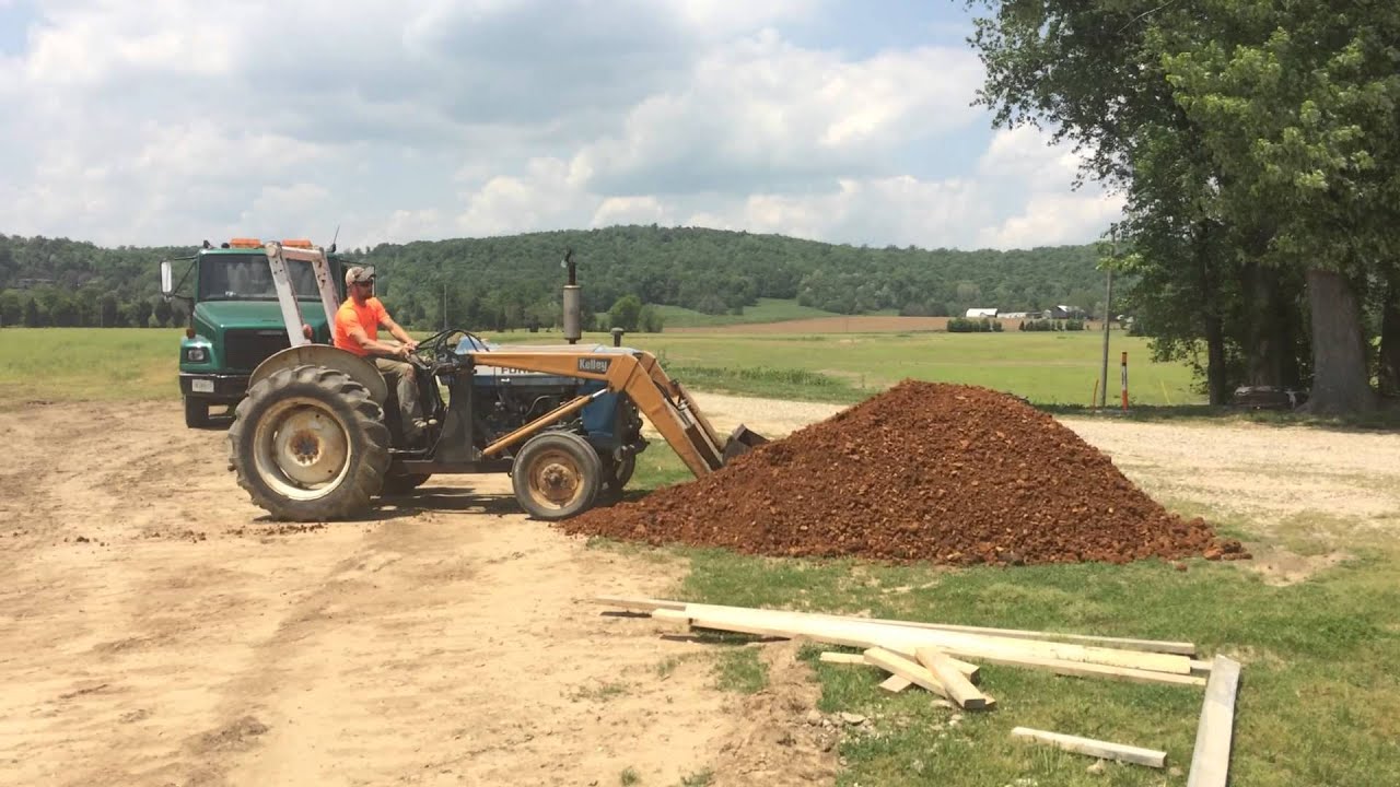 Old Ford Tractor spreading stone with front end loader