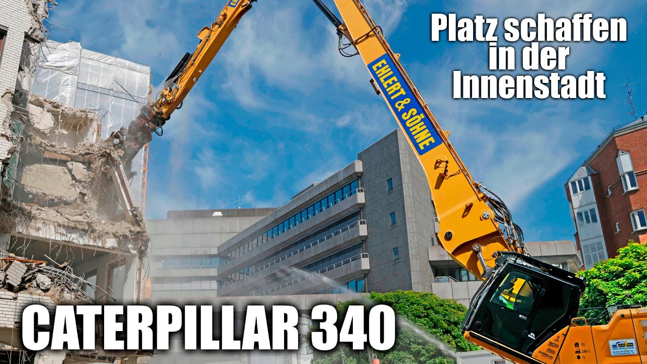 CATERPILLAR 340 mighty high reach demolition excavator tearing down office building downtown