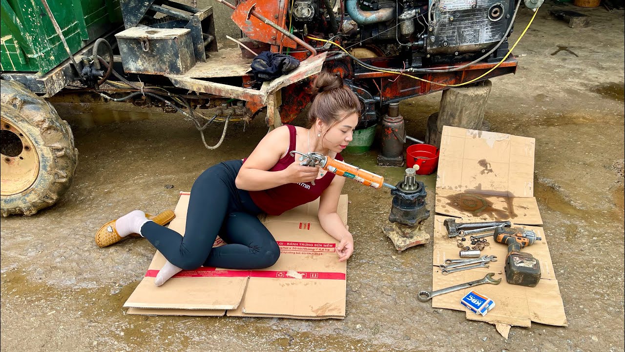 As usual, the female mechanic is repairing and replacing the tractor axle bearings.