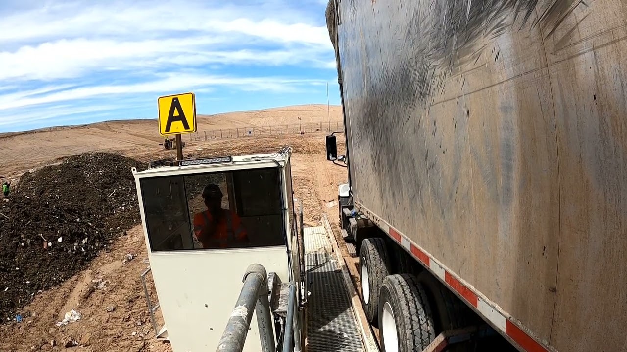 Backing onto the landfill tipper, tipper view.