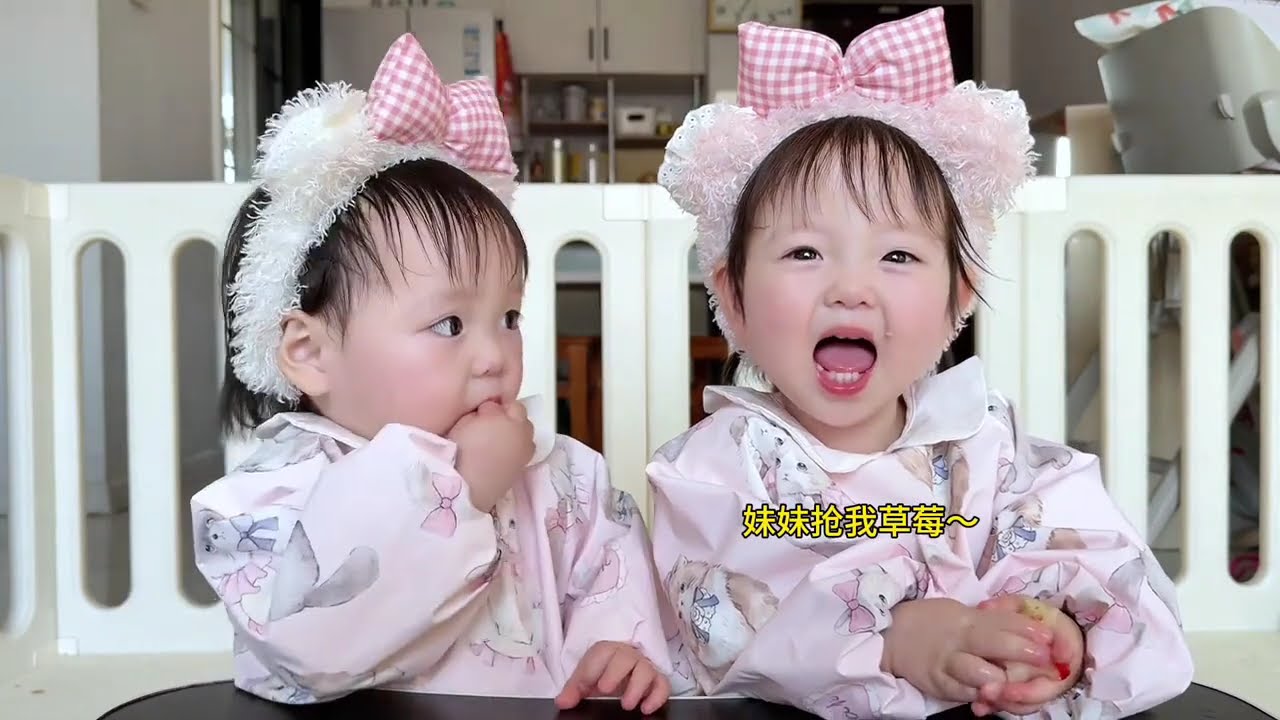 A battle of wits and courage to get a bite of her sister's strawberry #twins #cutebabies