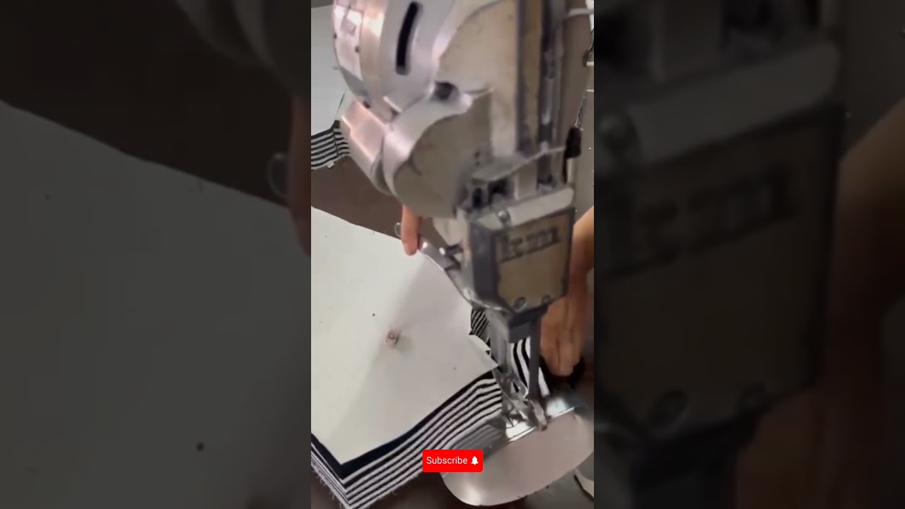 skill multiple layers of striped fabric in a textile factory workshop for garment production 