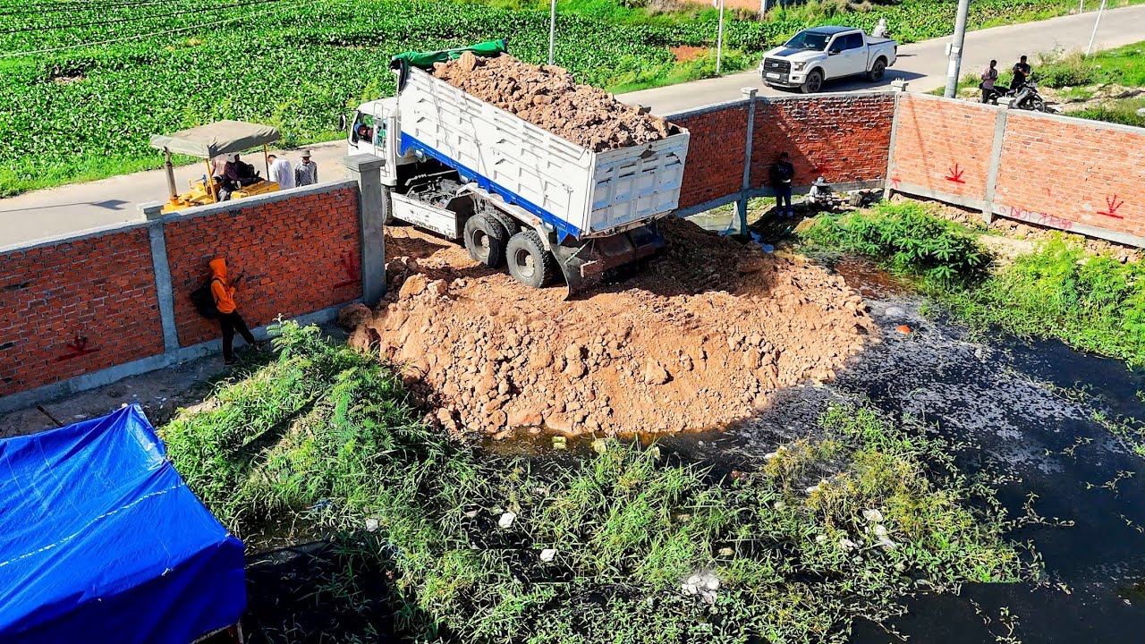WONDERFUL START LANDFILL TASK! Use Dozer KOMATSU D31P Pushing soil clear &Dump Trucks Unloading soil