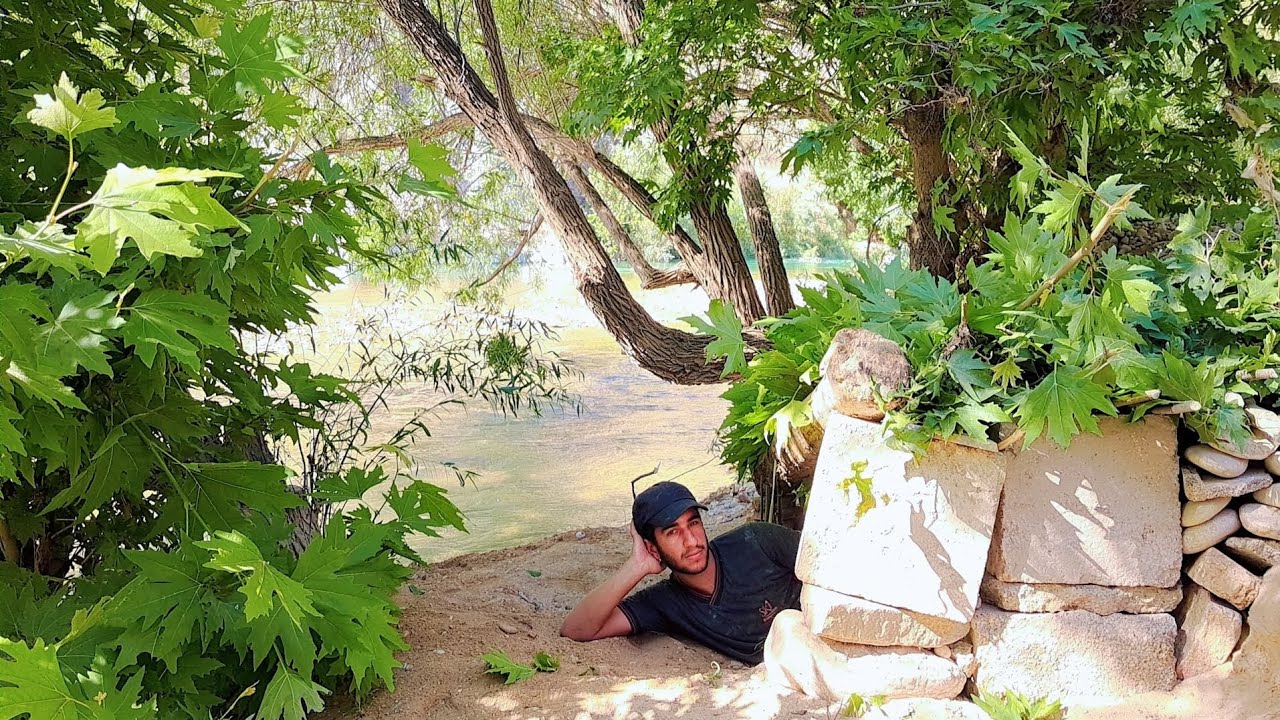 Building a nest in the sand by the river