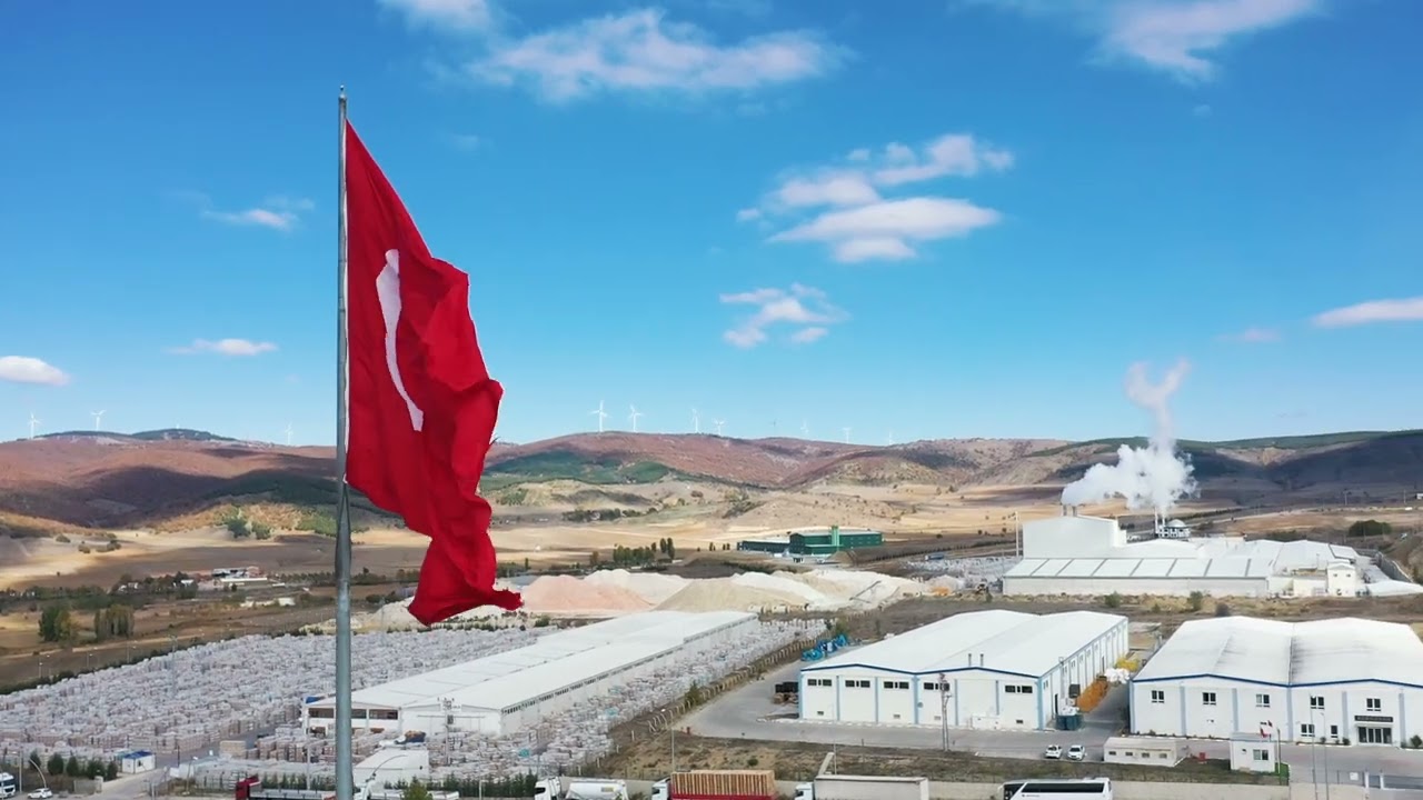 Turkish Flag Waving in Front of Industrial Complex