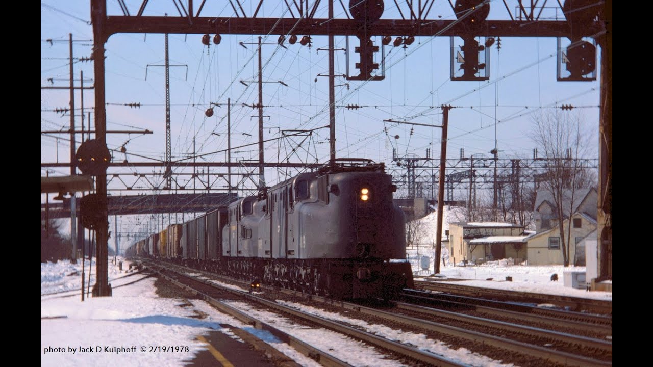Amtrak GG-1 roars past GG-1 powered freight on the NEC, 2/19/1978