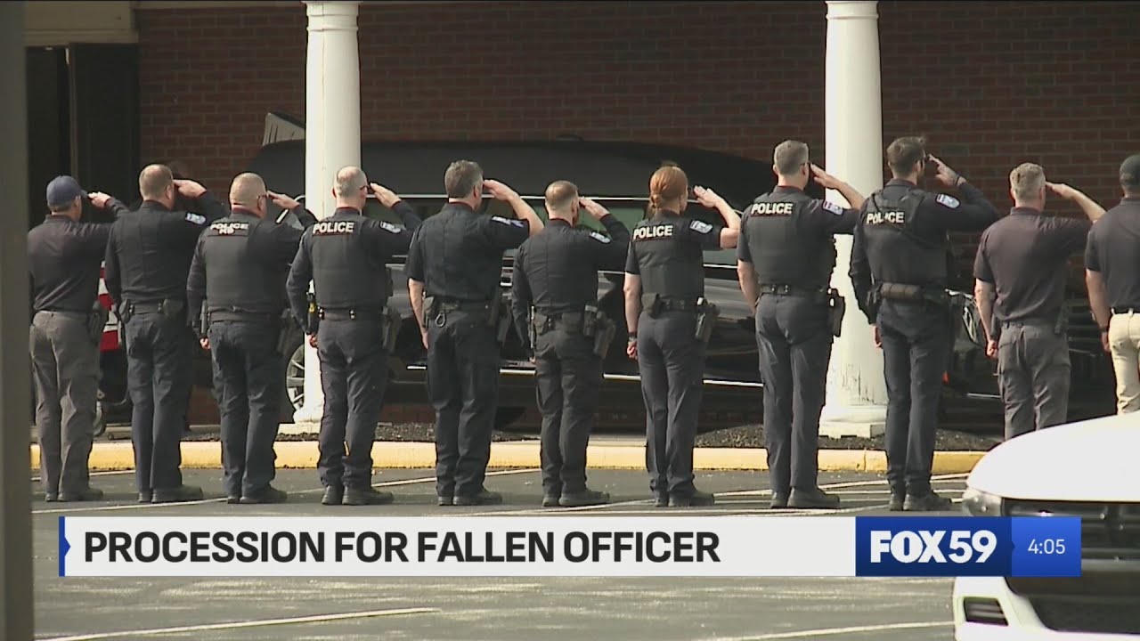 Law enforcement officers pay respect as body of fallen officer Brian Elliott transported to funeral