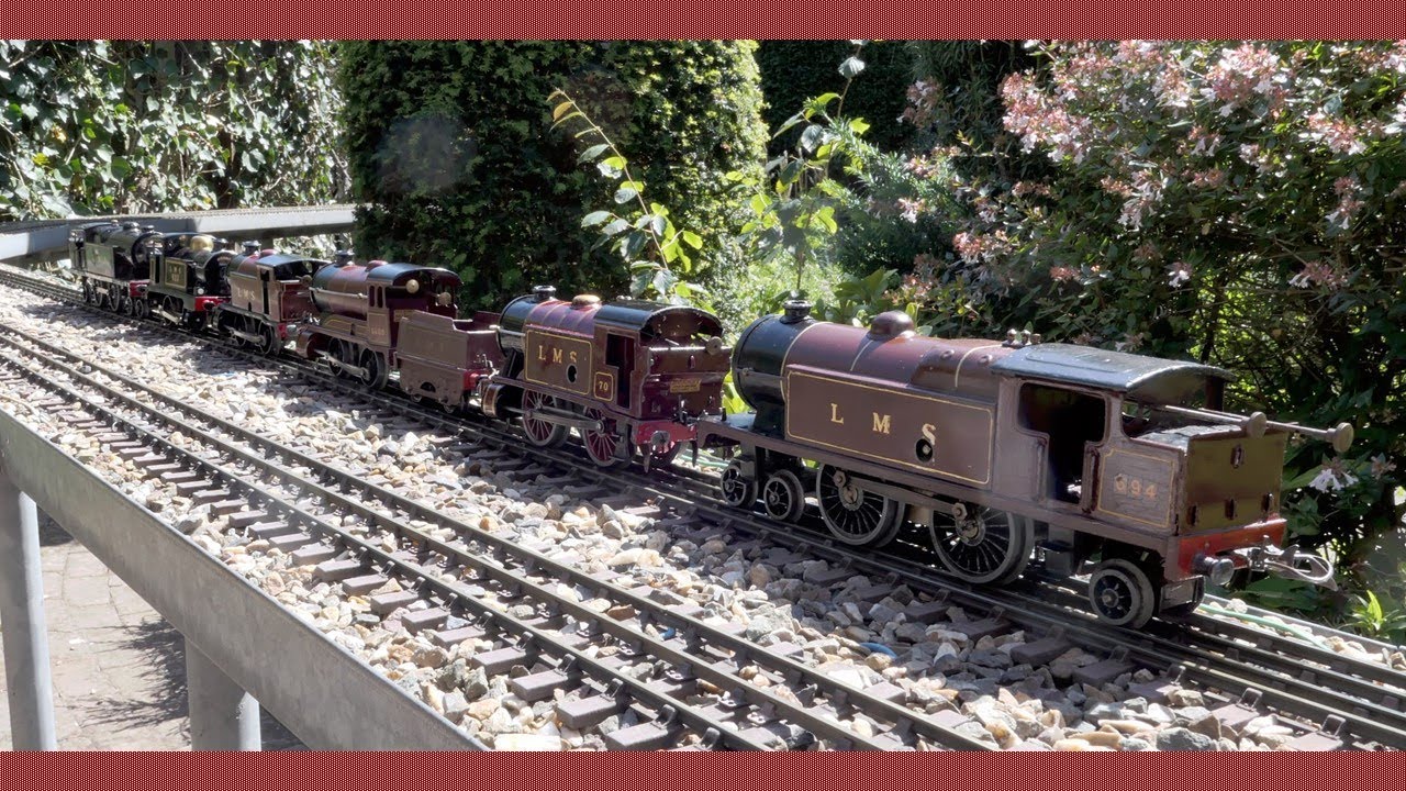 A number of Hornby LMS clockwork locomotive in different liveries with passengers and freight trains
