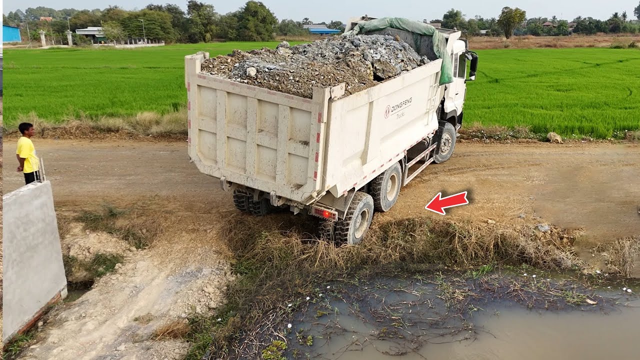 First Process Dongfeng trucks Start dumping Stone fill 25x50 size & push by Powerfu dozer 