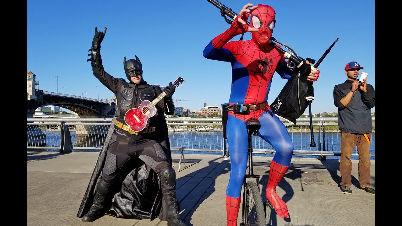 Ukulele Batman Returns to Battle Unicycle Bagpipe Spider-Man in a Theme Song Throw Down!