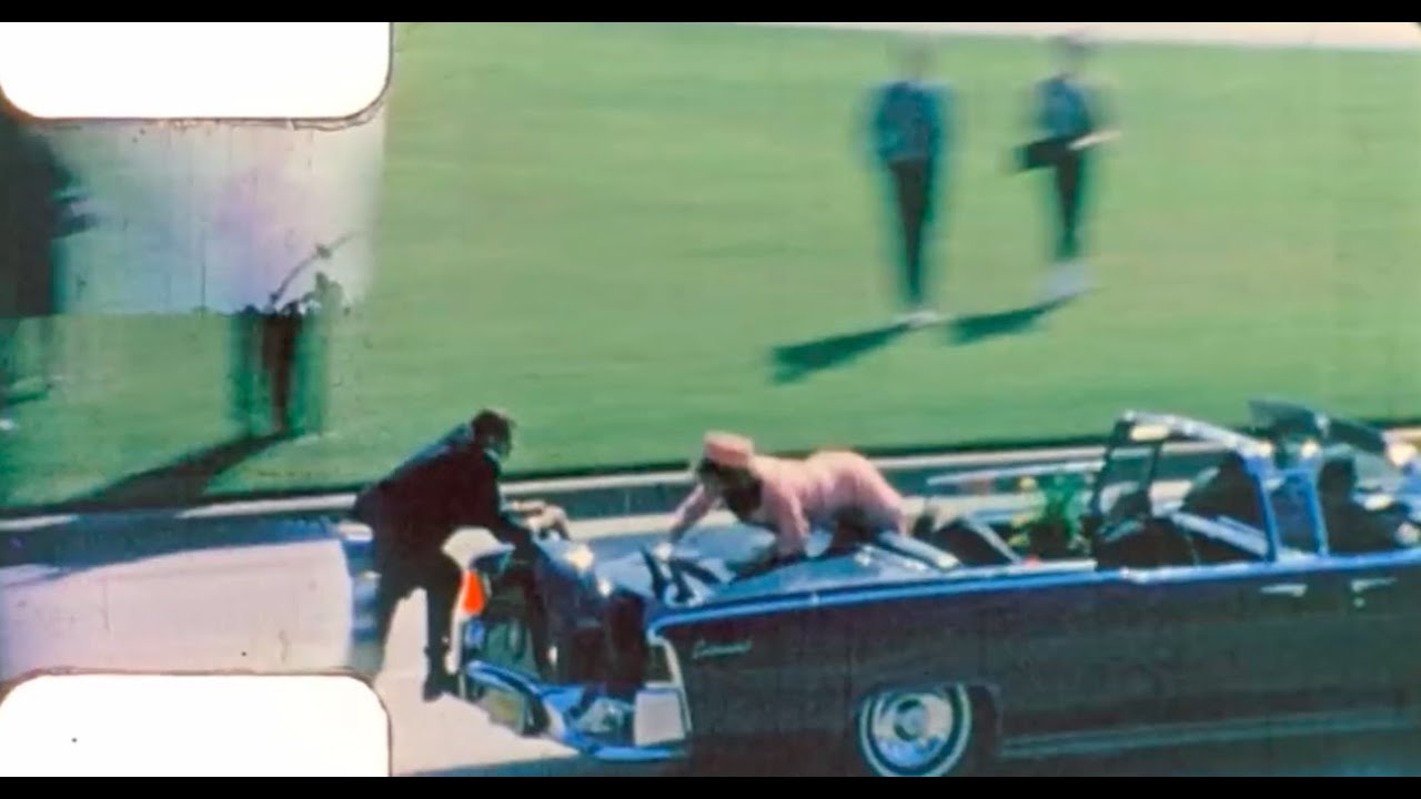 Did the limousine slow down or stop before JFK was fatally hit?