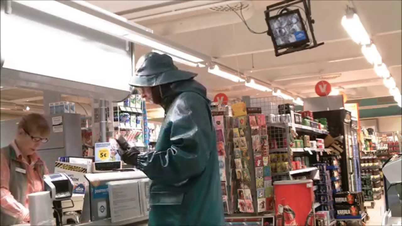 green rainwear worn over black rubber suit