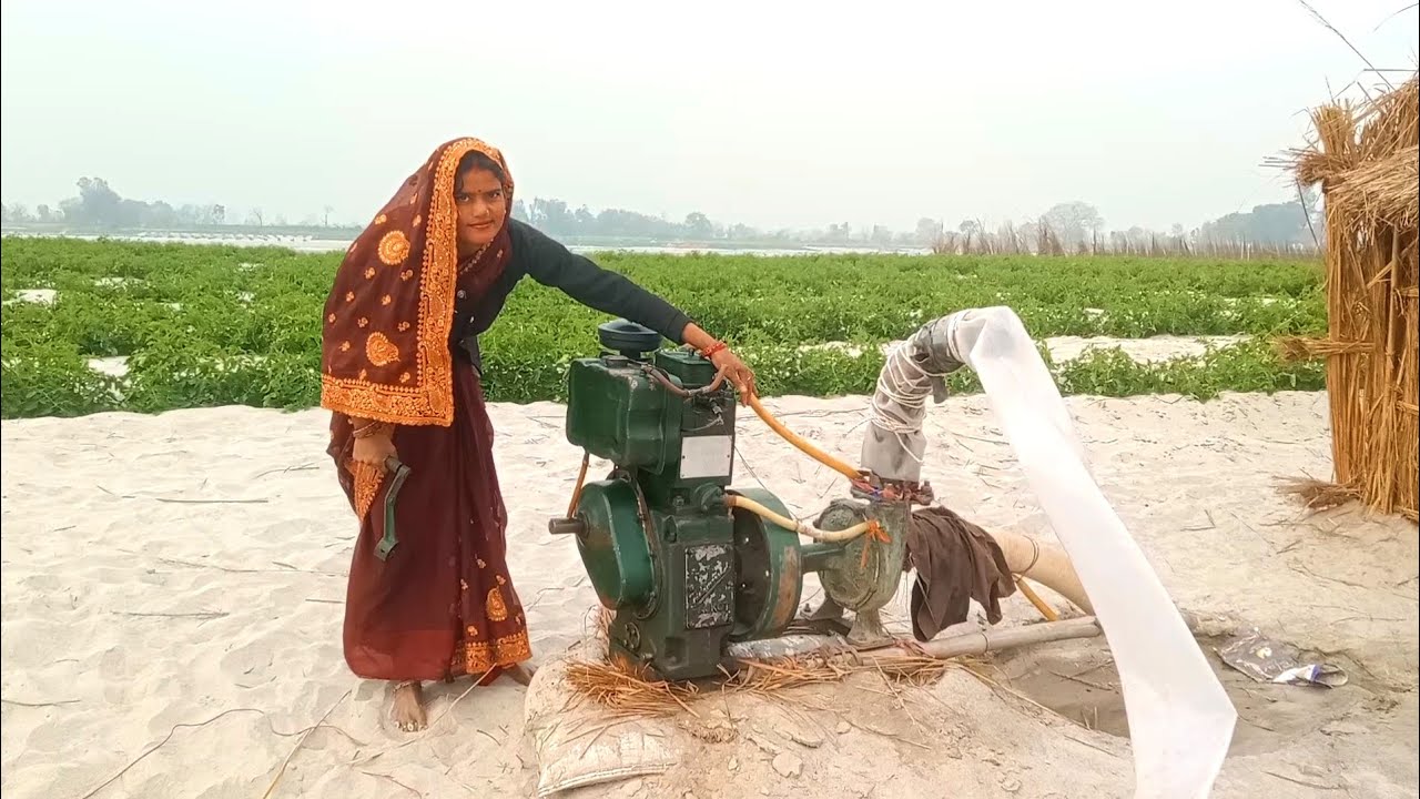 Diesel engine water pump start village female farmer irrigation hard work 