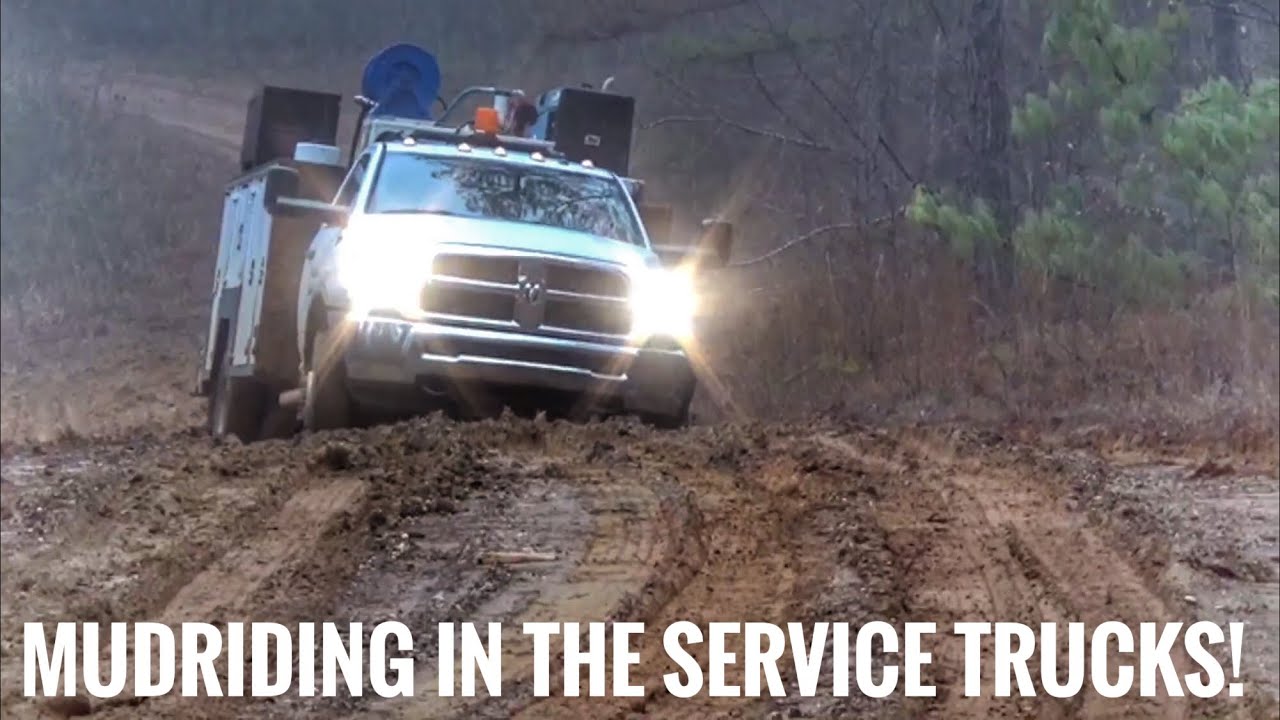 4x4 Ford and Ram service trucks in mud