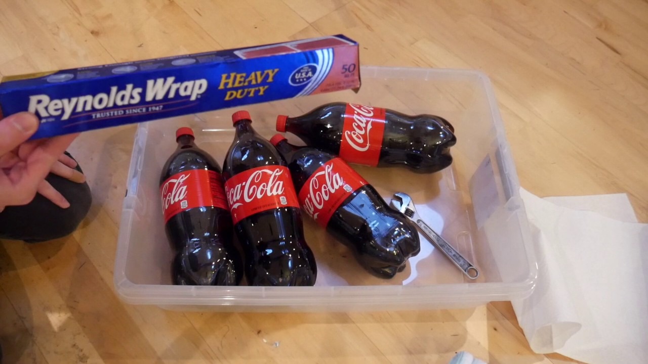 Cleaning rust off a drum with Coca-Cola.