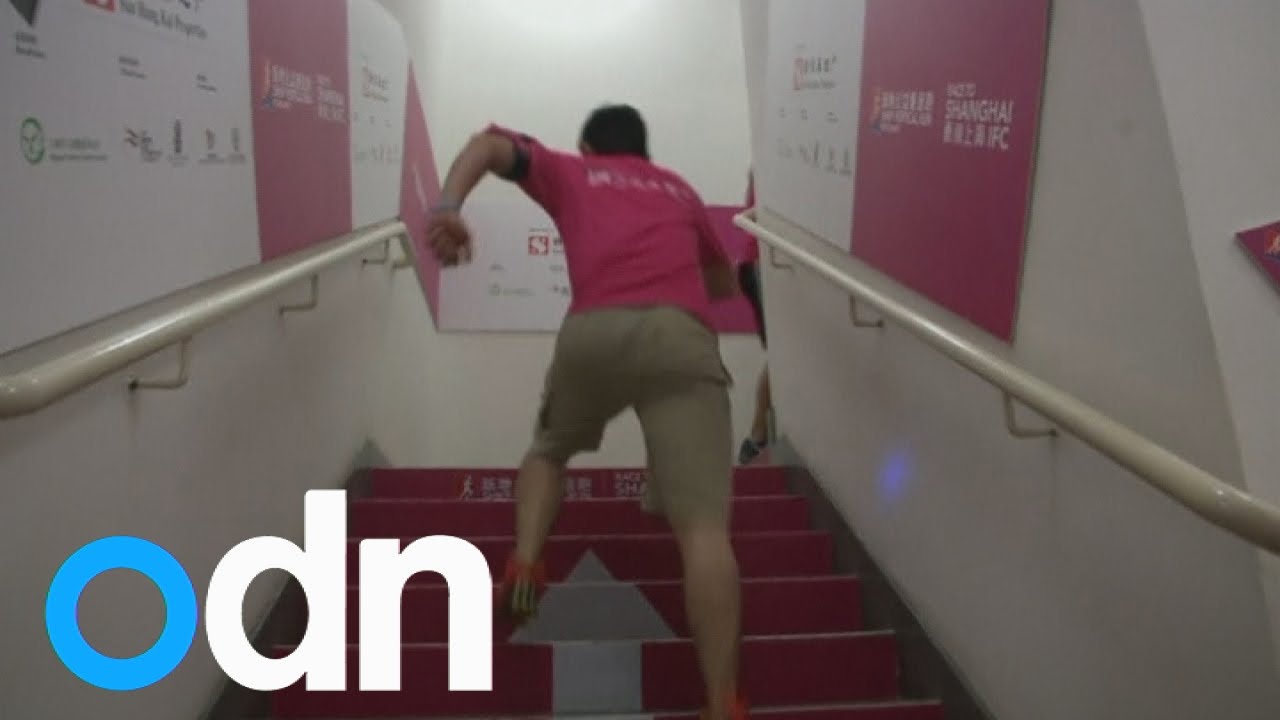 Vertical runners race up the stairs in Shanghai skyscraper