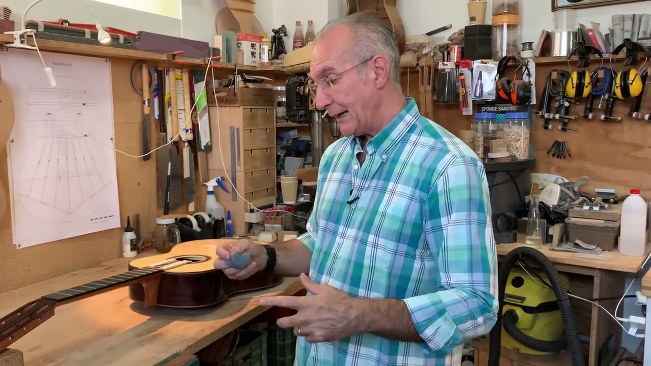 French polishing the difficult areas of a guitar.