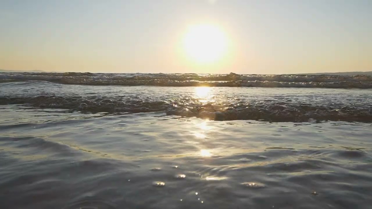 Sand beach waves at sunset, reveal shot slow motion | Free stock footage