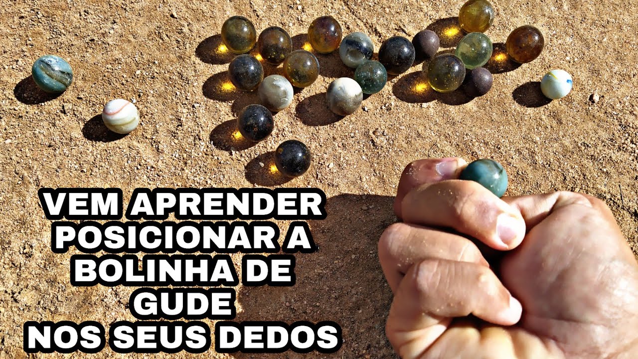 como posicionar a bolinha de gude nos dedos
