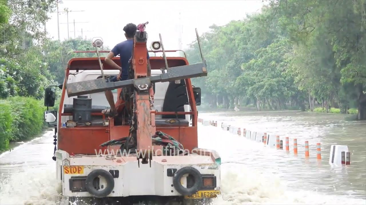 Commuters struggle through flooded streets in Delhi during monsoon
