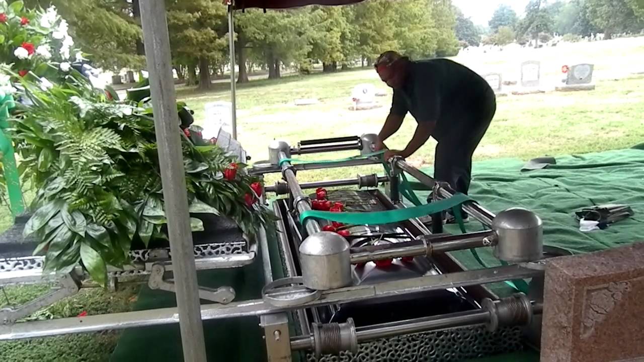 38. getting ready to lower the casket in the ground.MP4