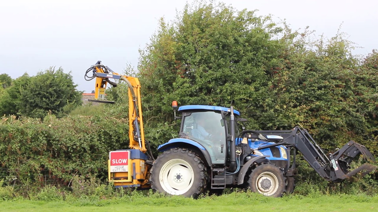 Tractor hedge cutter with saw blade