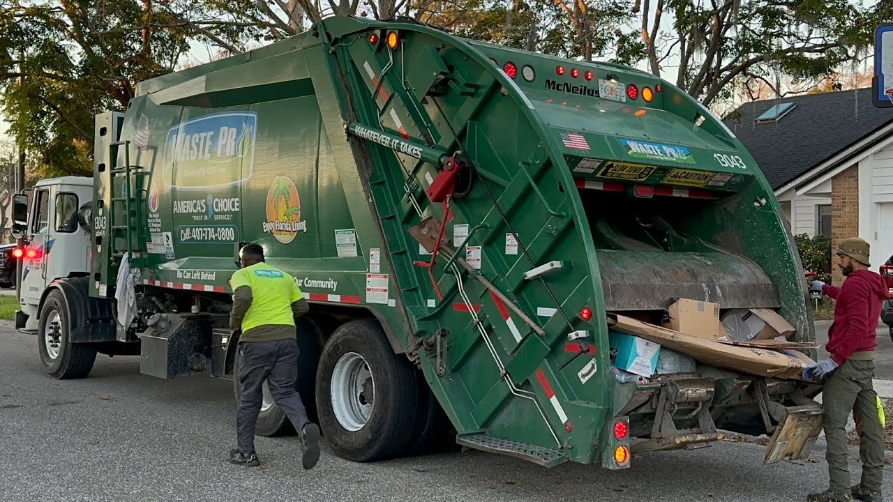 Waste Pro Rear Loader Garbage Truck Packing Post Christmas Trash in the Evening
