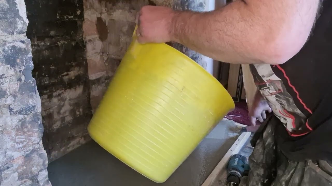 Part 3 of the fireplace videos mixing and pouring self levelling cement for fireplace.