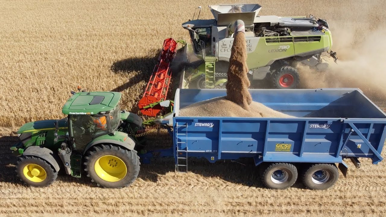 Combining in the CLAAS lexion with Stewart Trailers, John Deere, and Fendt