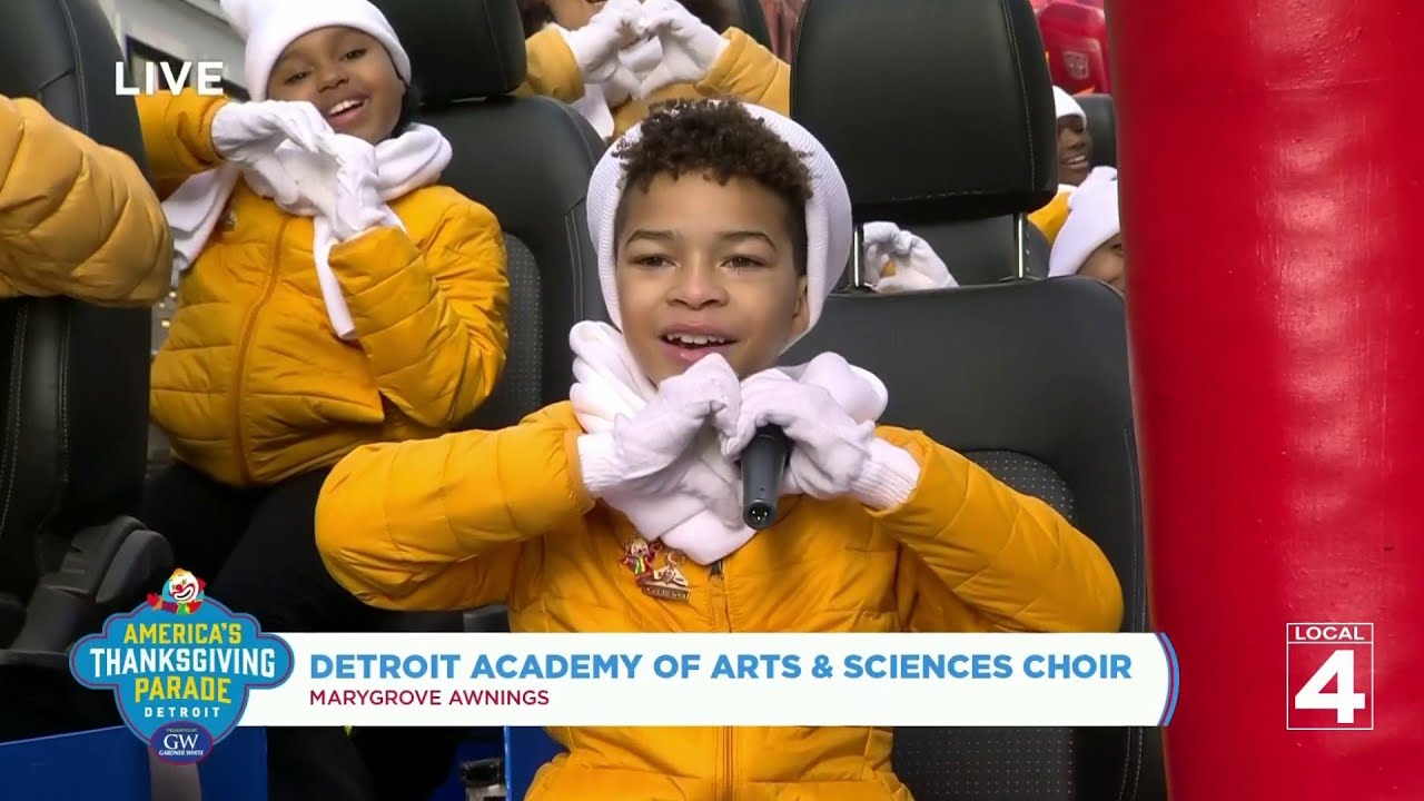 Children of Detroit Academy of Arts & Sciences Choir sing along the Thanksgiving parade route