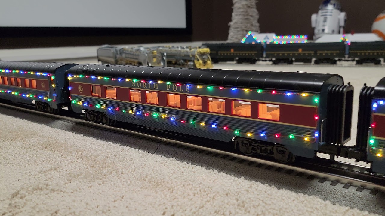 Lionel Legacy Pilot Y3 pulling MTH North Pole Christmas passenger cars.